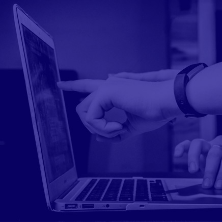 Doigts pointés vers l'écran ordinateur portable